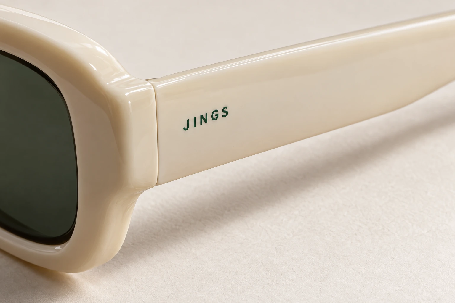 Printed JINGS identity on ivory acetate